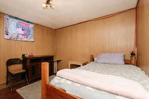 Bedroom 4 featuring wooden walls