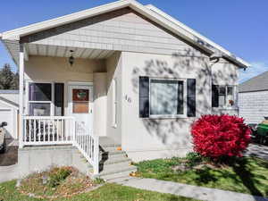 View of front of property featuring stucco siding and a front lawn