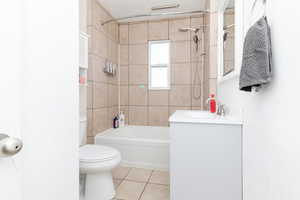 Full bath with vanity,  shower combination, and light tile patterned flooring