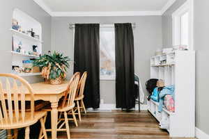 Dining space featuring light wood-style flooring and ornamental molding