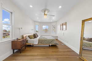 Bedroom with light wood-type flooring, recessed lighting, and a ceiling fan