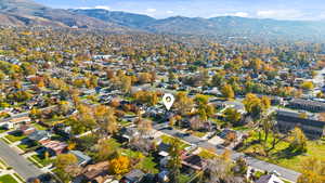 Aerial view of property and surrounding area featuring a mountain backdrop