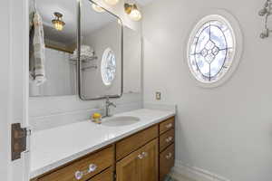 Full bath featuring vanity, plenty of natural light, and a shower with curtain