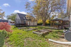 View of yard with a gazebo, a garden, a trampoline, and a garage
