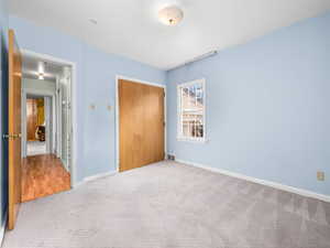 Unfurnished bedroom with carpet floors and a closet