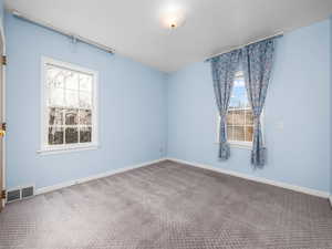 Unfurnished room featuring carpet flooring and baseboards