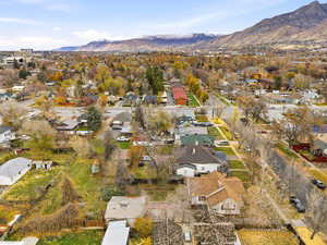 Aerial overview of property's location featuring a mountainous background and nearby suburban area