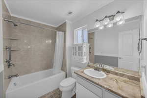Bathroom with shower / bath combo, vanity, ornamental molding, and tile patterned floors