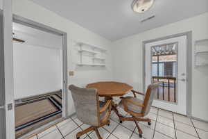 Dining space with light tile patterned floors