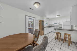 Dining space featuring light tile patterned floors