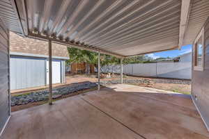 Fenced backyard with a patio