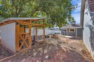 Fenced backyard with exterior structure and an outbuilding