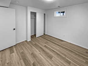 Unfurnished bedroom with a closet and light wood finished floors