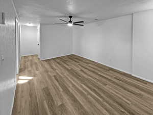 Spare room with ceiling fan and light wood-type flooring