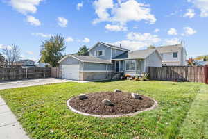 Tri-level home featuring concrete driveway, an attached garage, and brick siding