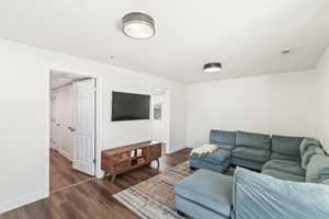 Living room with dark wood-type flooring and a textured ceiling