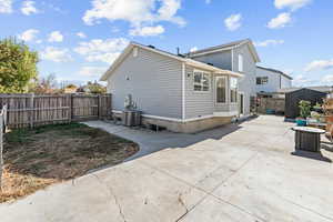 View of home's exterior featuring a patio area, a fenced backyard, and a storage unit