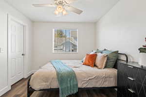 Bedroom featuring dark wood-style floors and ceiling fan