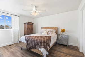 Bedroom featuring wood finished floors and a ceiling fan