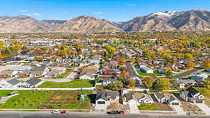 Aerial overview of property's location featuring a mountainous background and nearby suburban area