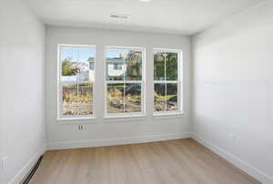 Dining area featuring healthy amount of natural light and light wood-style floors