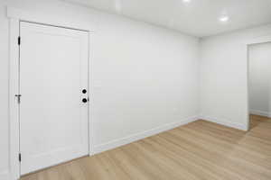 Spacious mud room featuring light wood-type flooring and recessed lighting