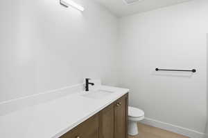 Guest/ Bedroom bathroom featuring vanity and light wood-style floors