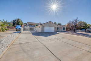 Ranch-style home featuring a gate, driveway, and an attached garage