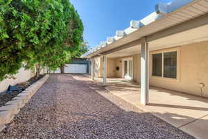 Fenced backyard with a patio area