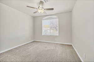 Spare room featuring carpet flooring and ceiling fan
