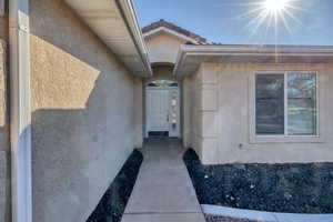 Doorway to property with stucco siding