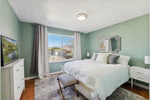 Bedroom featuring dark wood-style floors and a textured ceiling