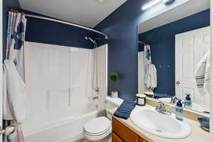 Bathroom featuring shower / bath combo with shower curtain and vanity