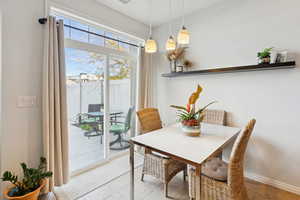 Dining space with baseboards and tile patterned floors