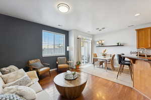 Living area with light wood-style floors and a textured ceiling