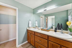 Bathroom featuring double vanity and light tile patterned floors