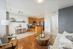 Living area featuring light wood-style flooring and recessed lighting