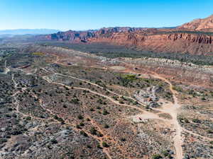 Aerial view of property's location with a mountain backdrop and rural landscape