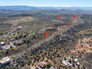 Aerial view of property and surrounding area featuring a mountain backdrop and rural landscape