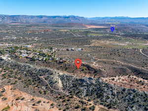 Aerial view of sparsely populated area featuring a mountain backdrop and a desert landscape