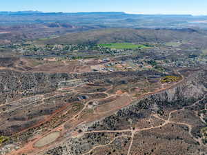 Aerial view of property and surrounding area with a mountainous background