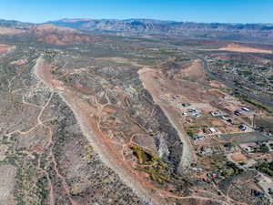 Aerial view of property and surrounding area featuring mountains and rural landscape