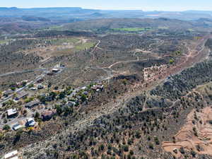 Aerial view of property and surrounding area featuring a mountainous background and rural landscape