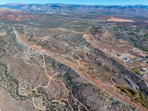 Aerial view of property and surrounding area featuring a mountain backdrop and rural landscape