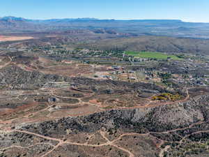Aerial view of property's location with a mountainous background and rural landscape