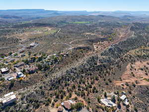Aerial overview of property's location featuring a mountainous background and rural landscape