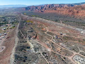 Aerial overview of property's location featuring a mountain backdrop and rural landscape