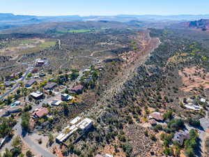 Aerial view of property's location with a mountainous background and a desert landscape
