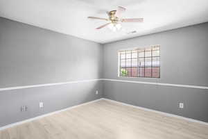 Unfurnished room with light wood-style flooring and a ceiling fan