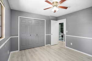 Unfurnished bedroom with light wood-style flooring, a ceiling fan, and a closet